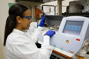 A lab worker analyzing DNA. Photo by National Cancer Institute on Unsplash